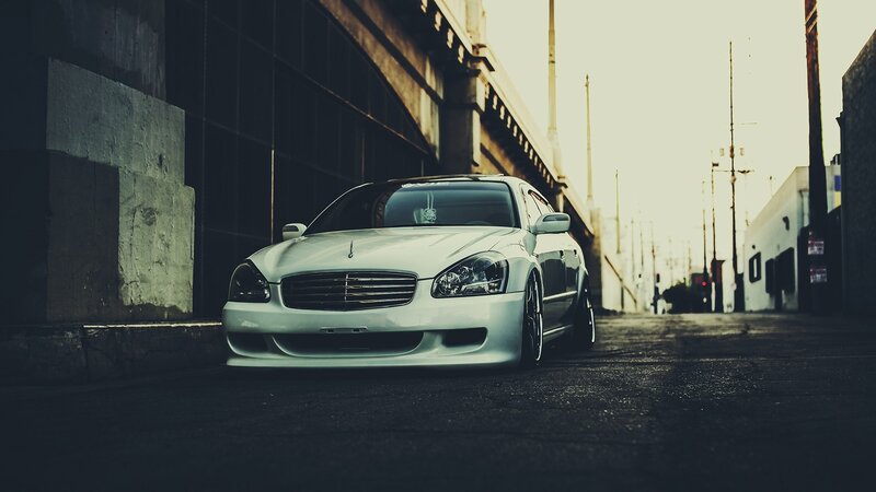 White Sedan Car — Dramatic, Sunset, Photograph, Building