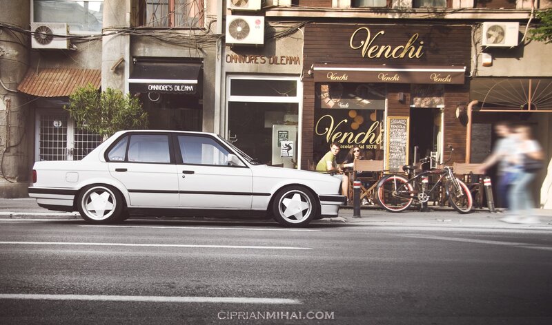 White Sedan Car — Urban, Afternoon, Photograph, Cafe