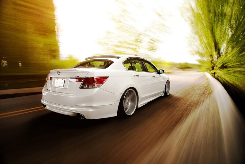 White sedan in motion on road