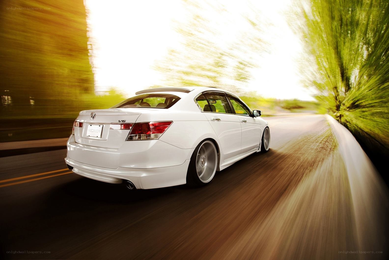 White sedan in motion on road