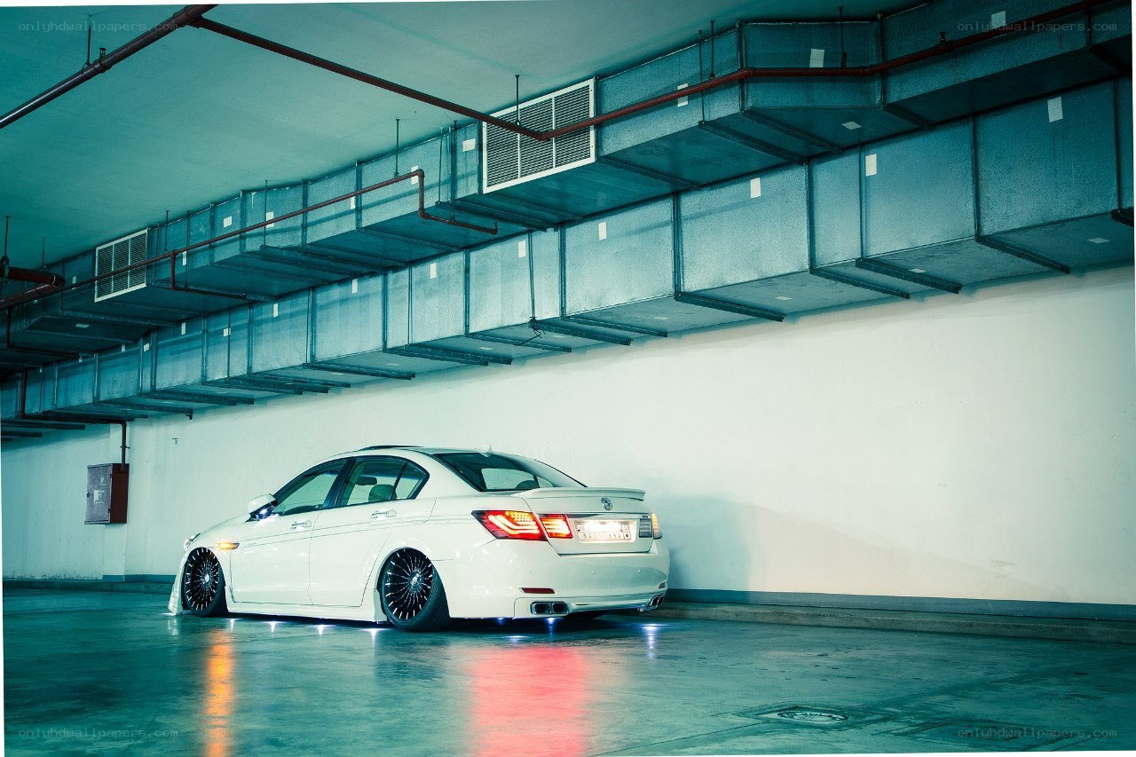White sedan in parking garage