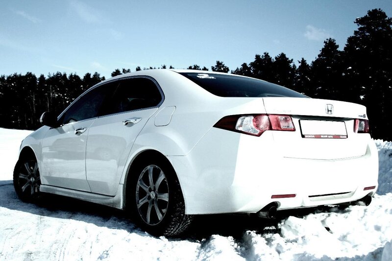 white sedan in snowy landscape