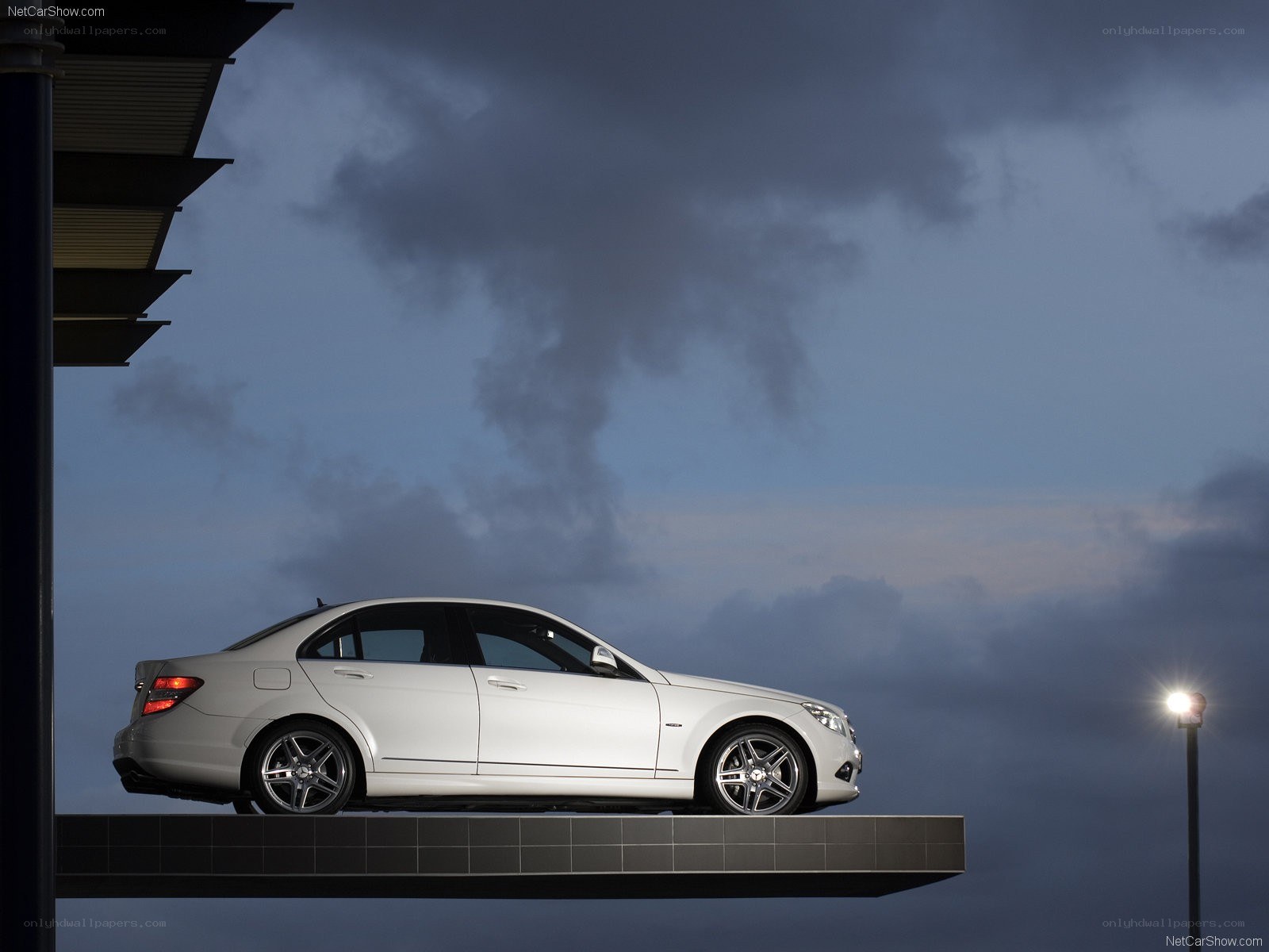 White sedan on a platform