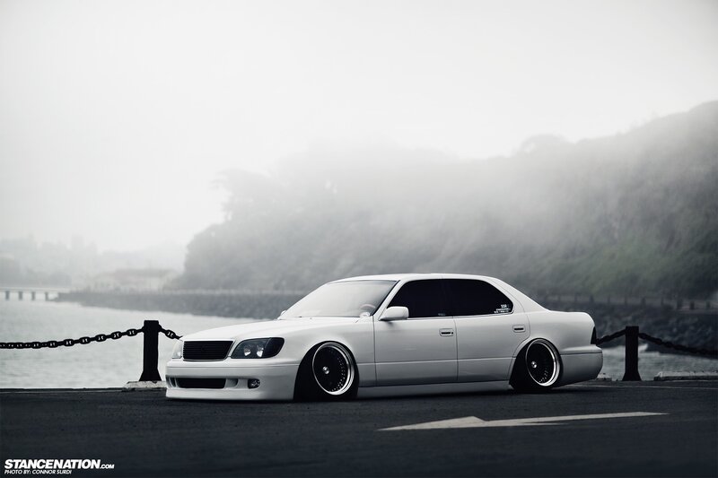 white sedan on foggy coast