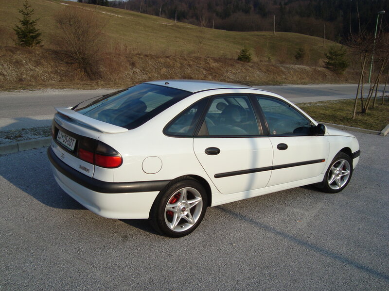 white sedan on gravel lot