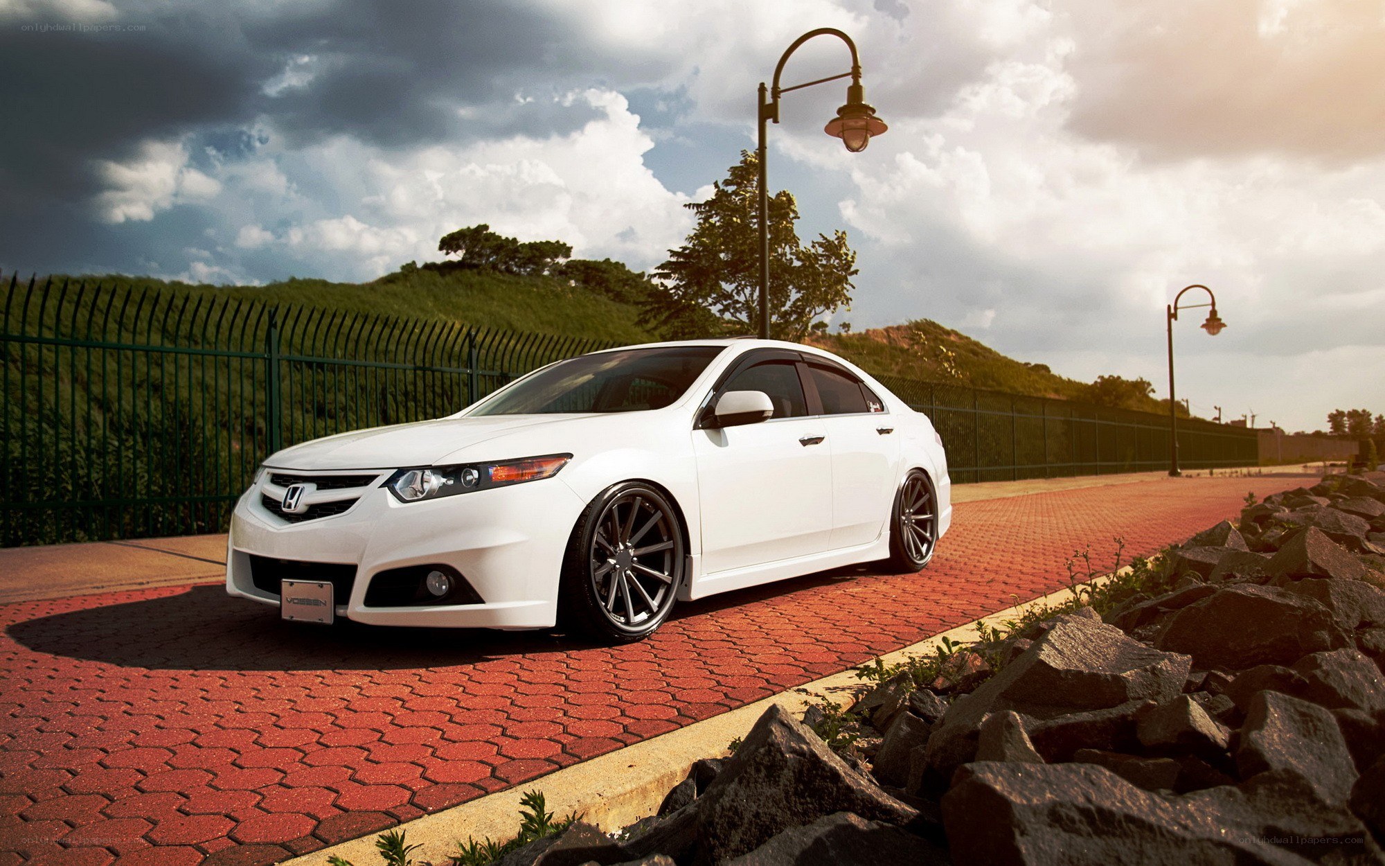 white sedan on red pavement