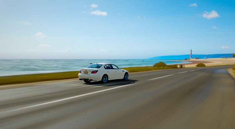 White Sedan on Road — Blue