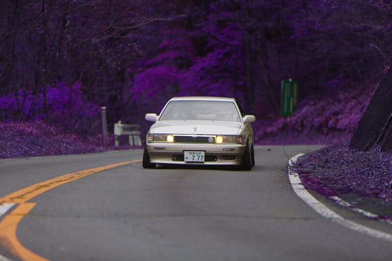 White Sedan on Road — Purple
