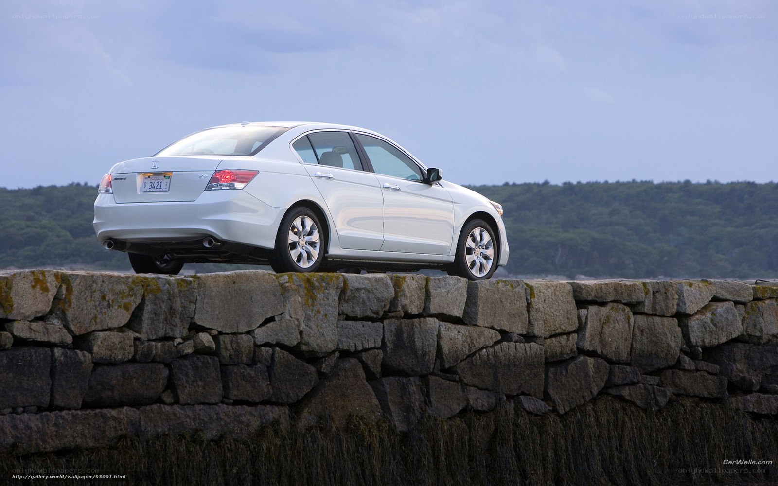 White sedan on stone wall