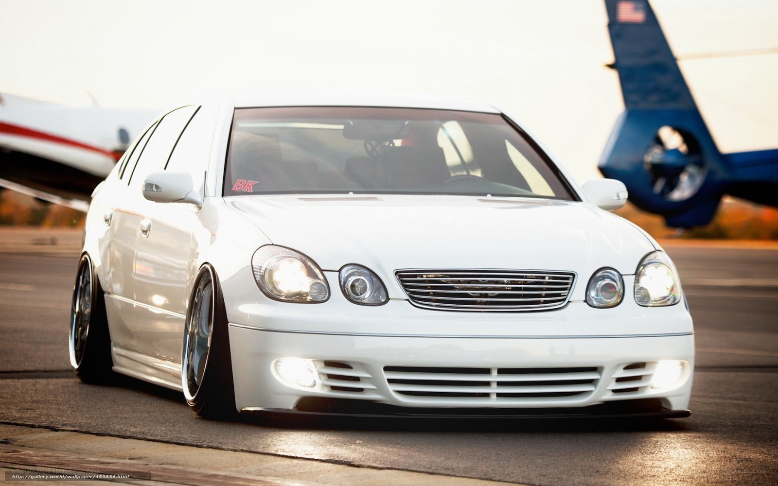 white sedan on tarmac