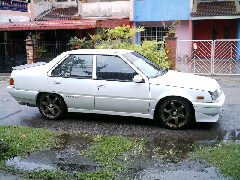 white sedan on wet street