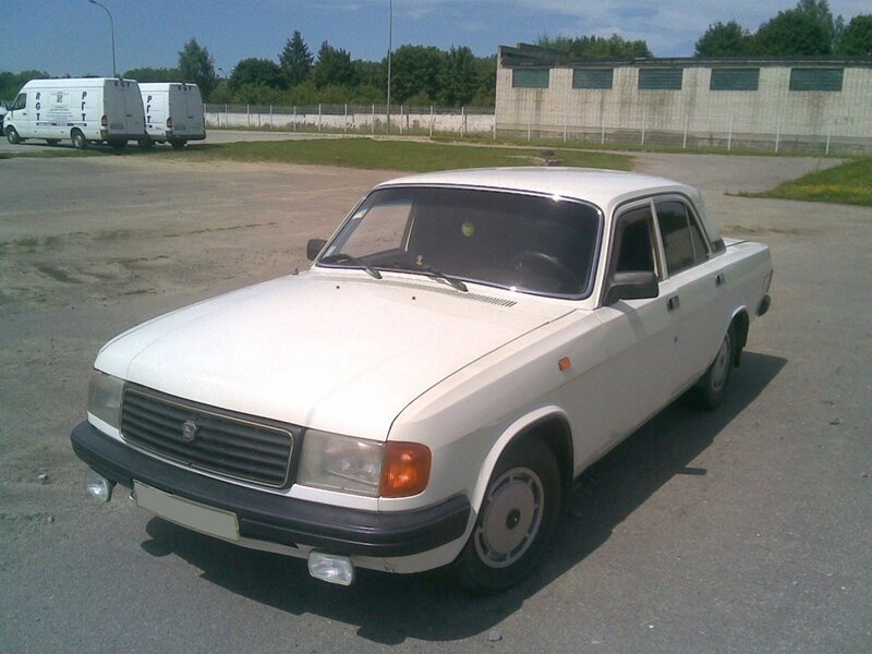 white sedan parked in lot