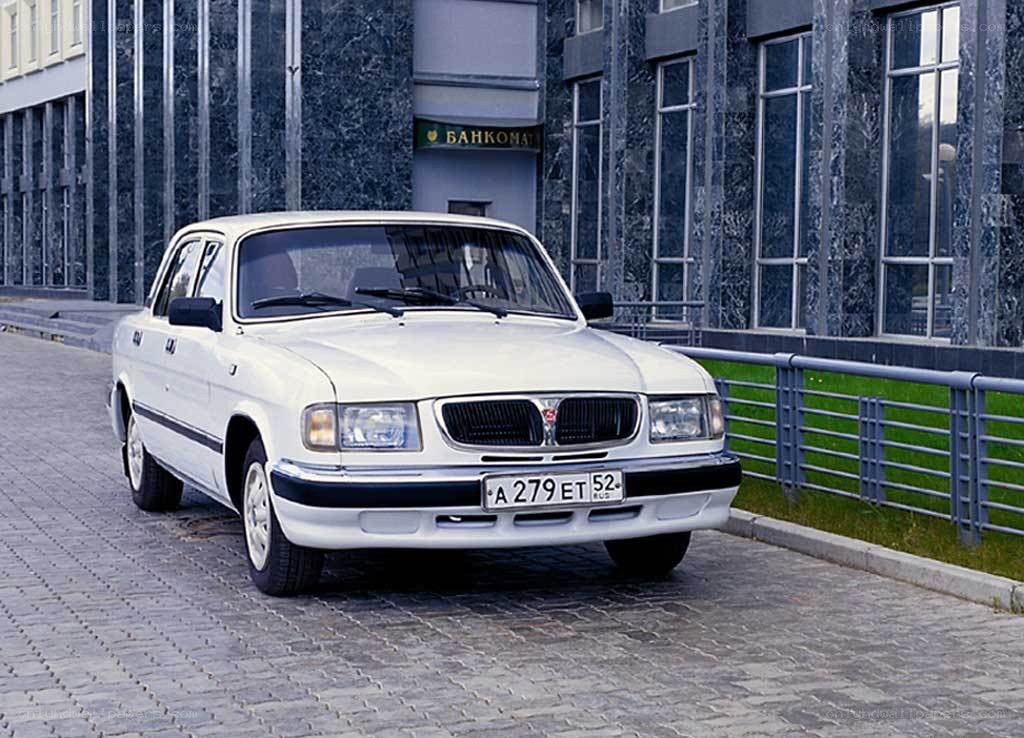 White sedan parked on cobblestone