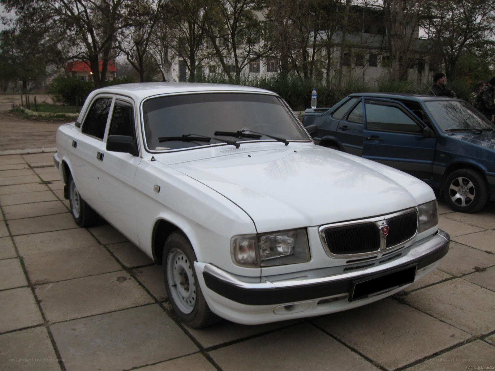 white sedan parked on pavement