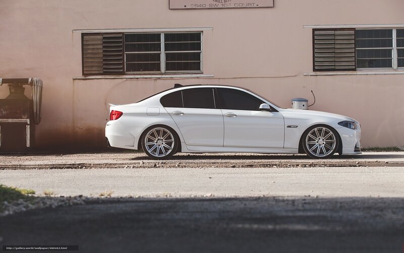 white sedan parked on street