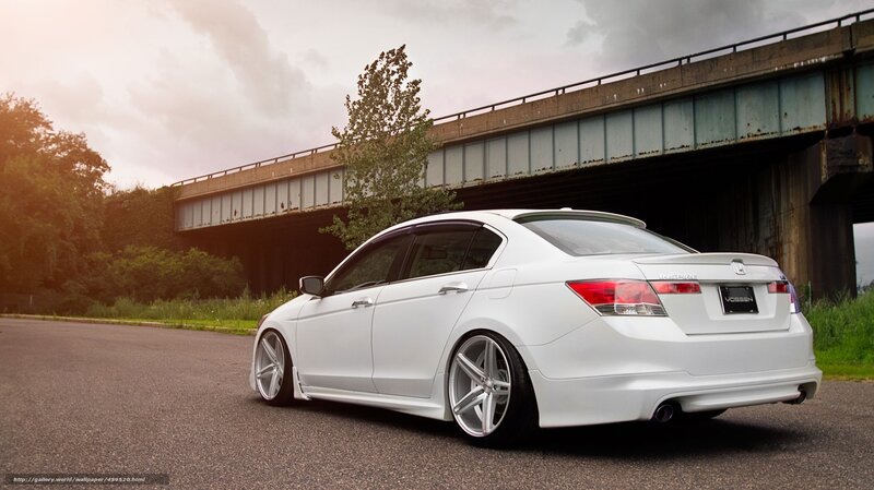 white sedan under bridge
