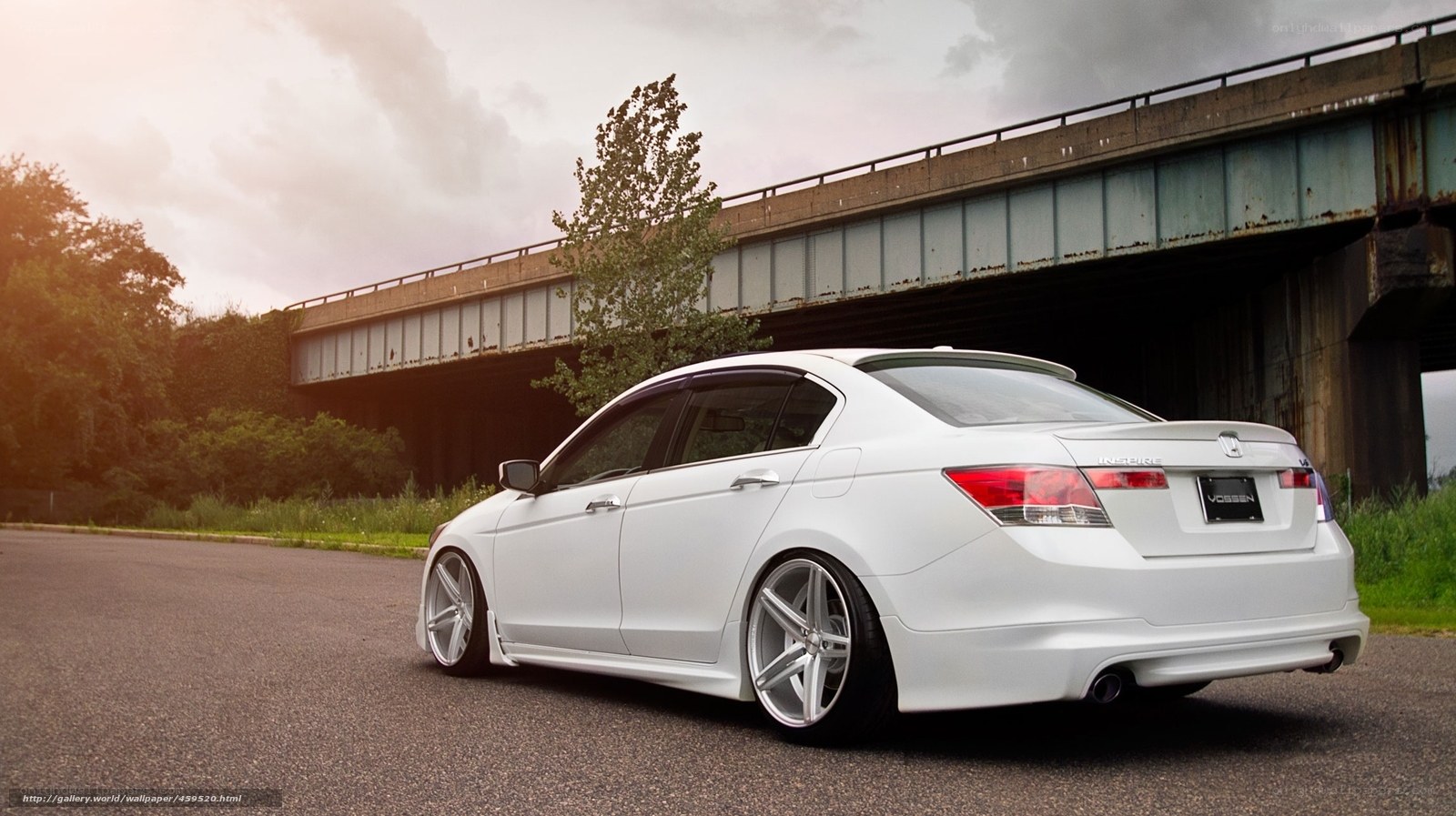 white sedan under bridge