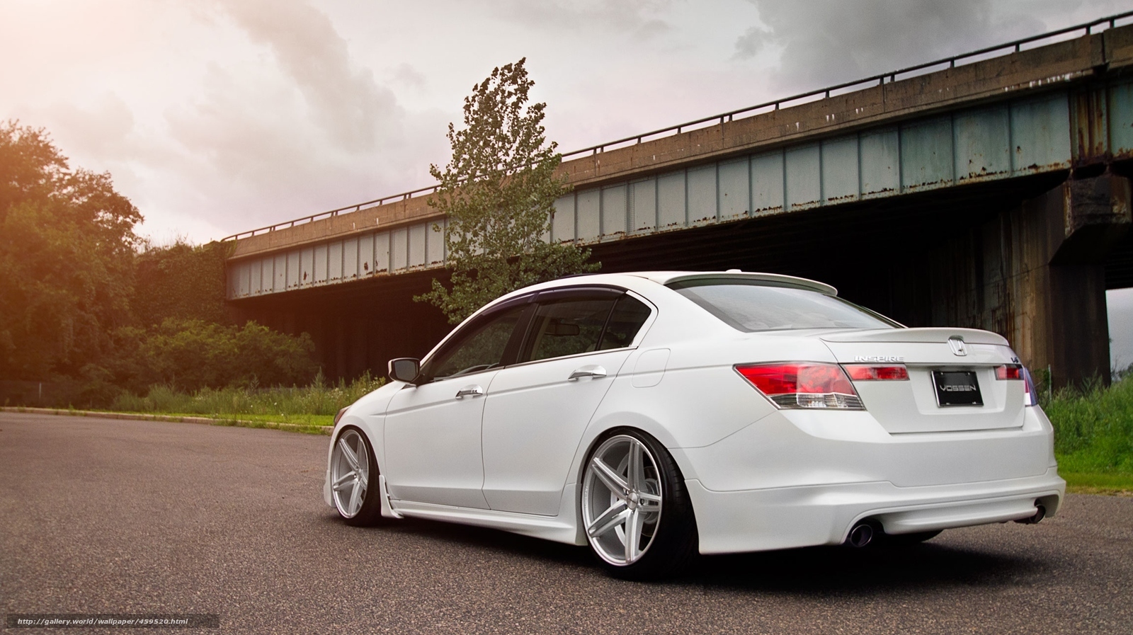 white sedan under bridge