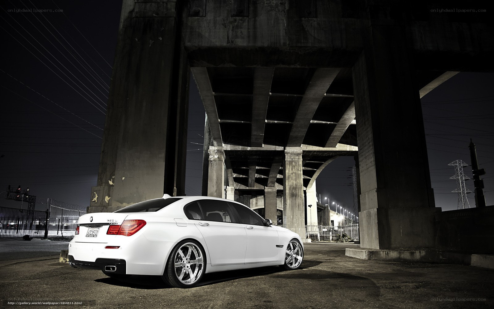 White sedan under highway overpass