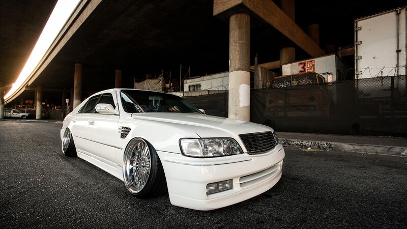 white sedan under highway