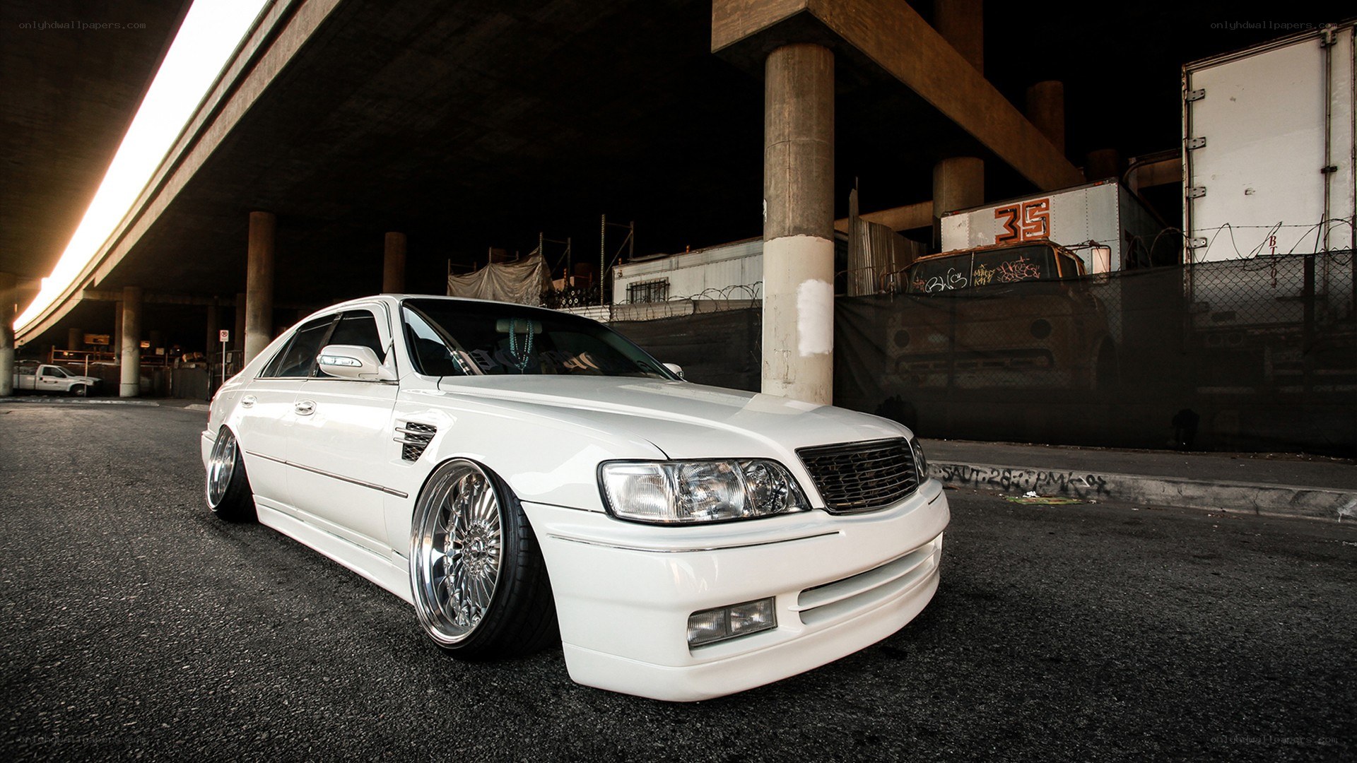 white sedan under highway