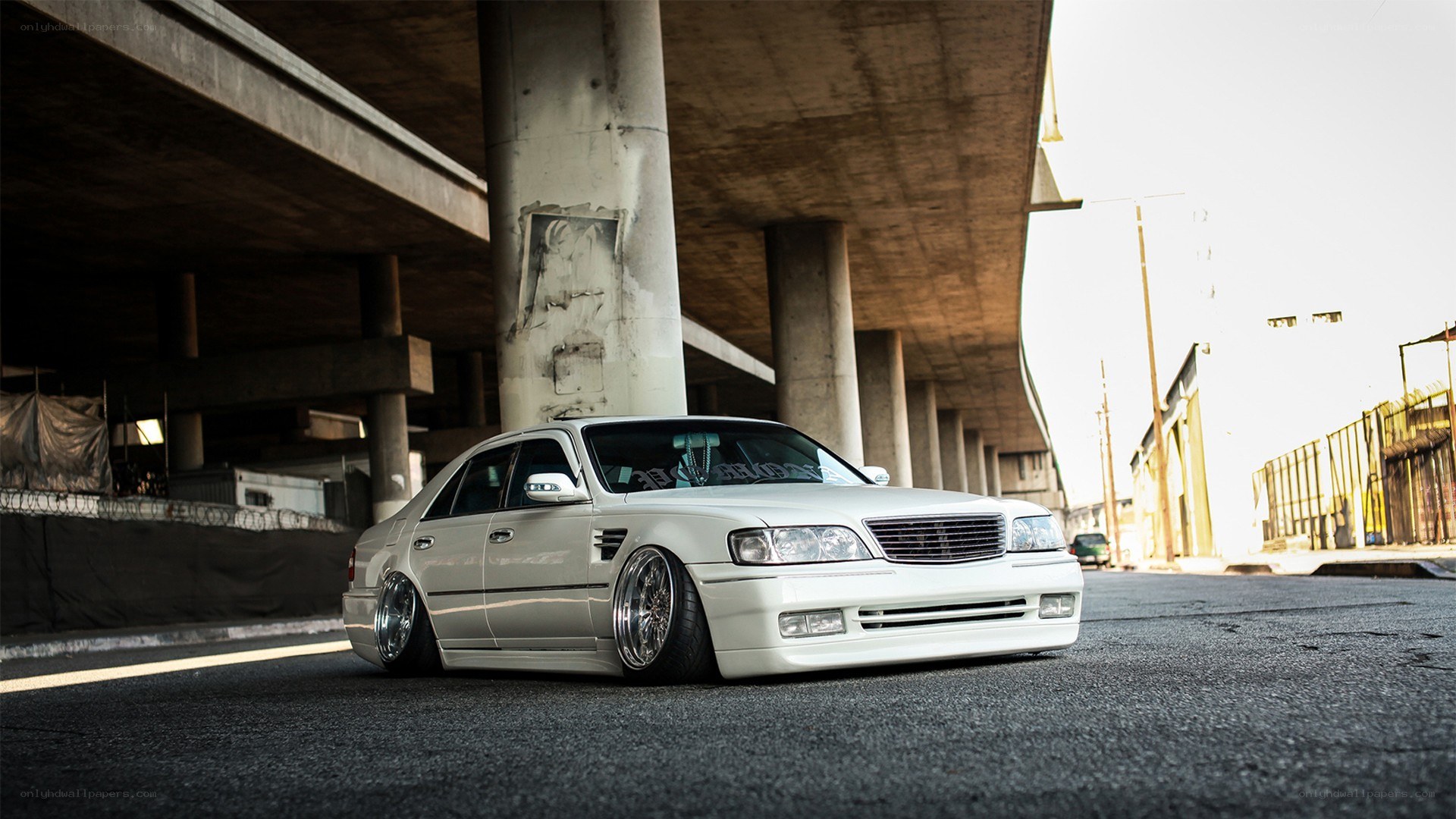 white sedan under overpass