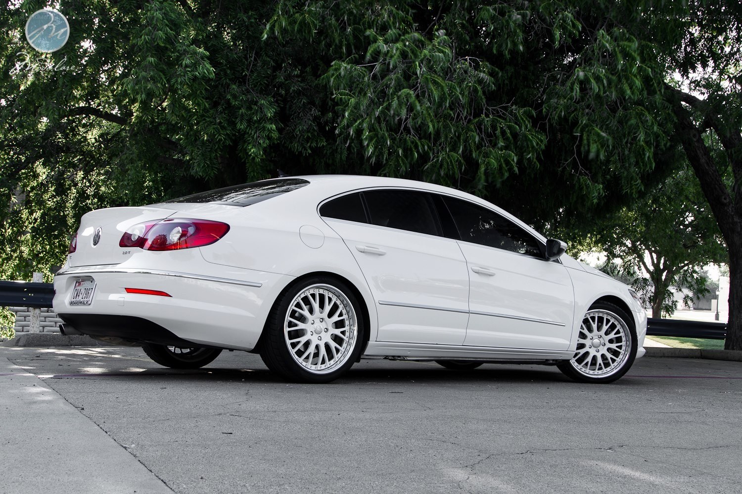 white sedan with custom wheels