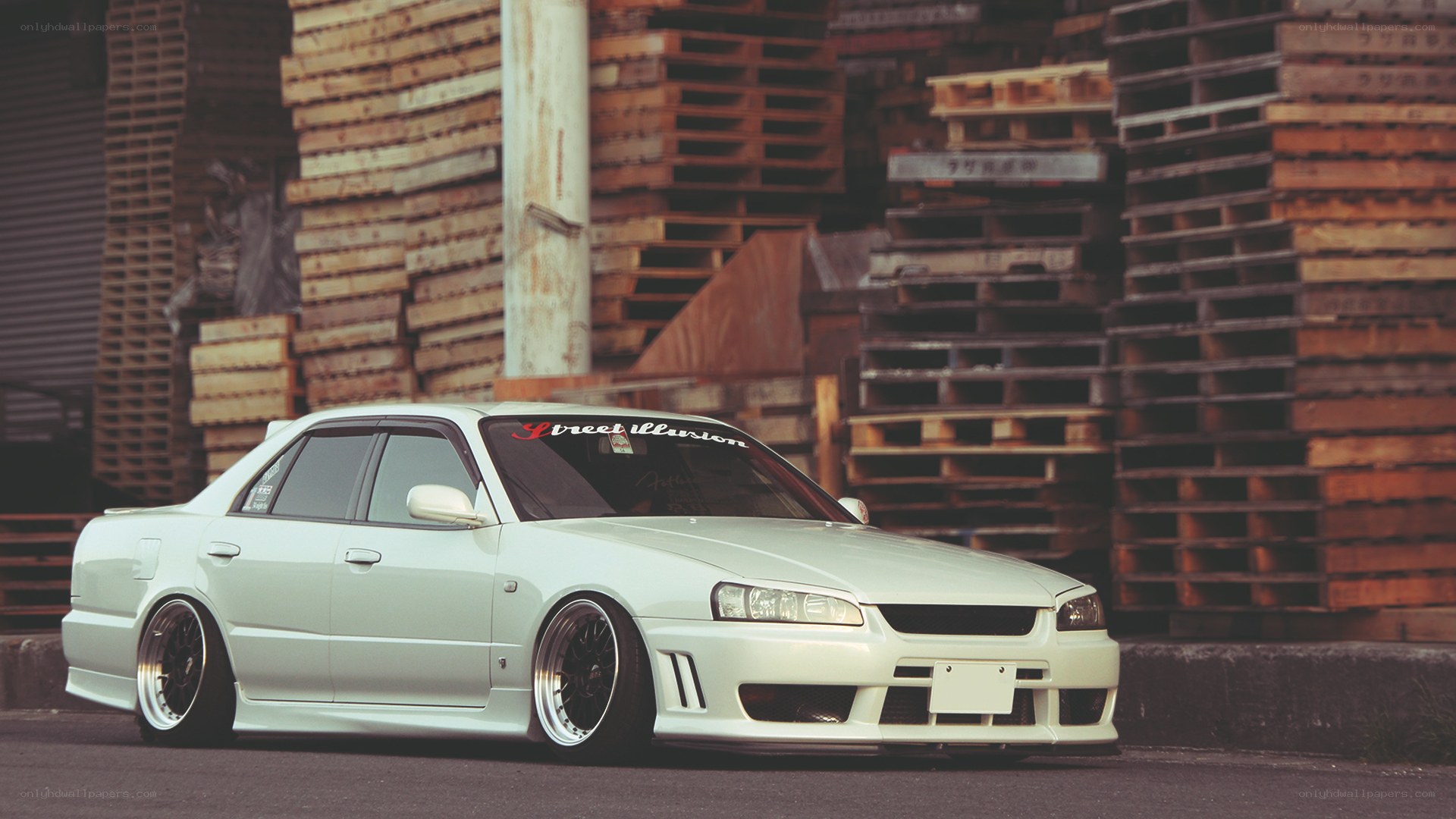 white sedan with custom wheels