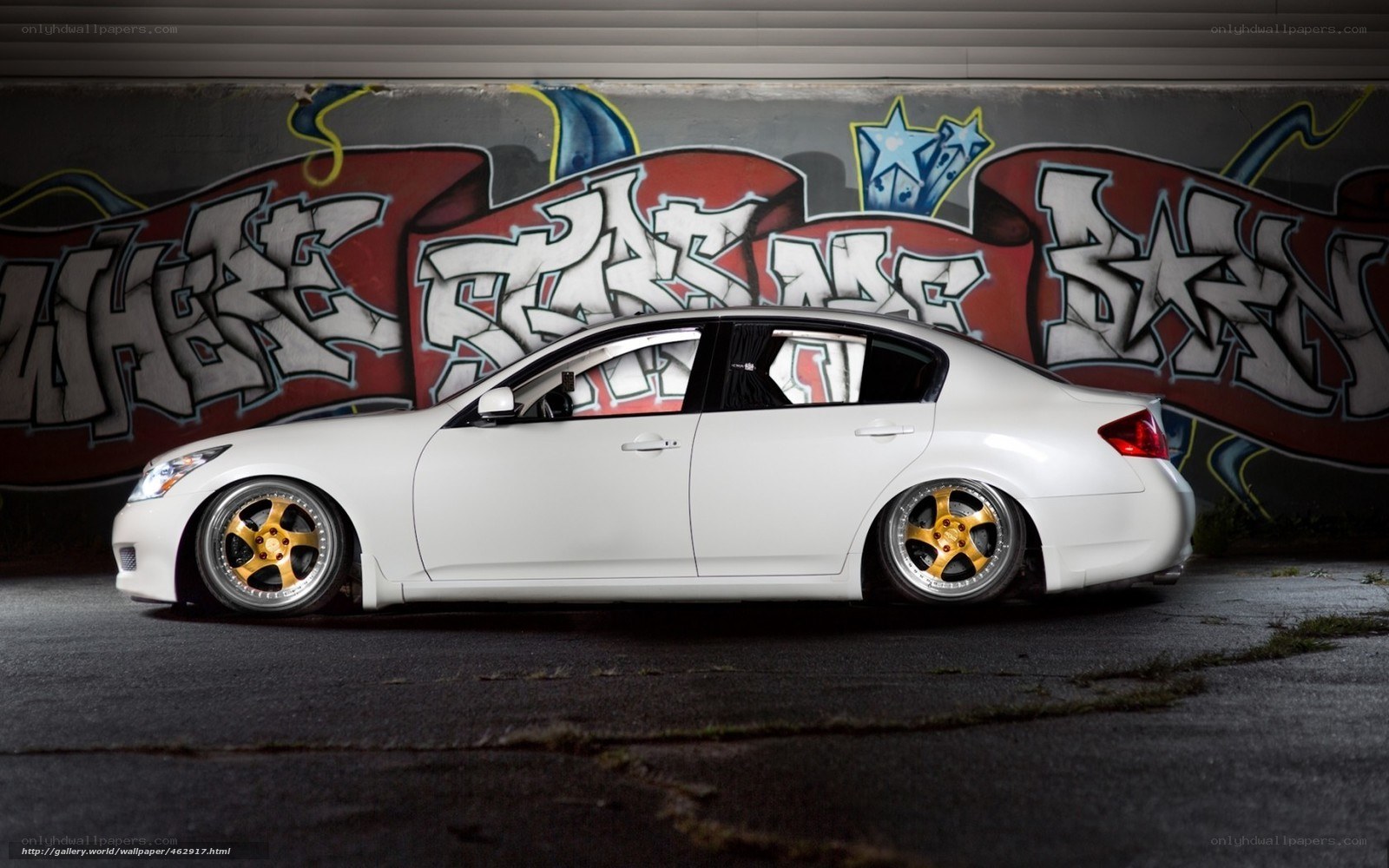 white sedan with gold wheels