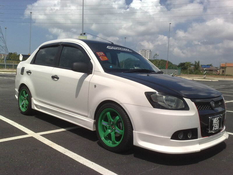white sedan with green wheels