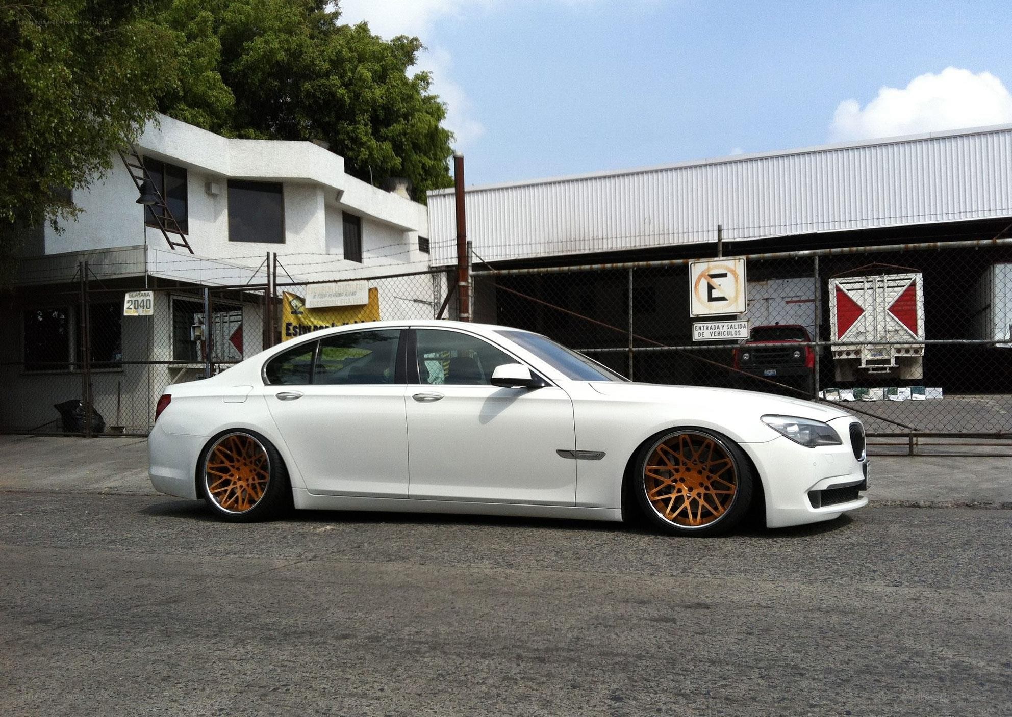 white sedan with orange wheels