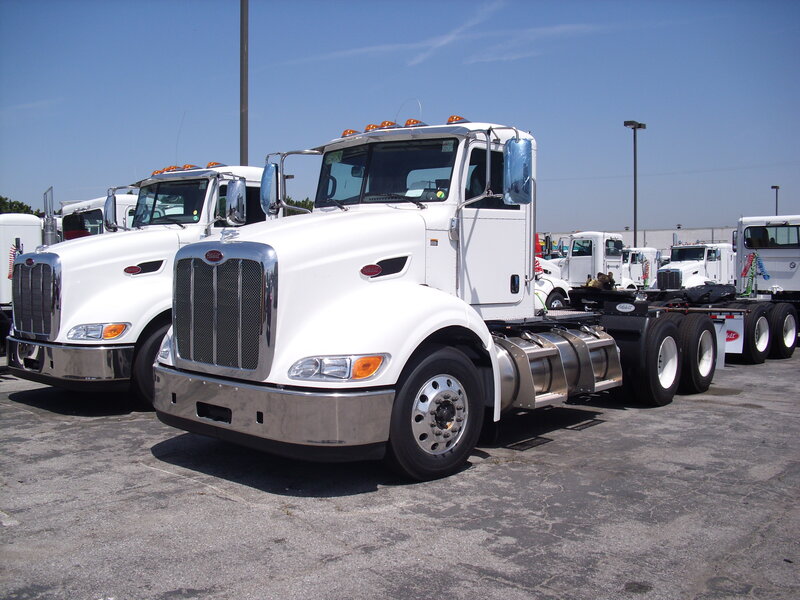 White Semi-trucks in Lot
