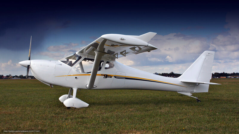 White single-engine aircraft on grass