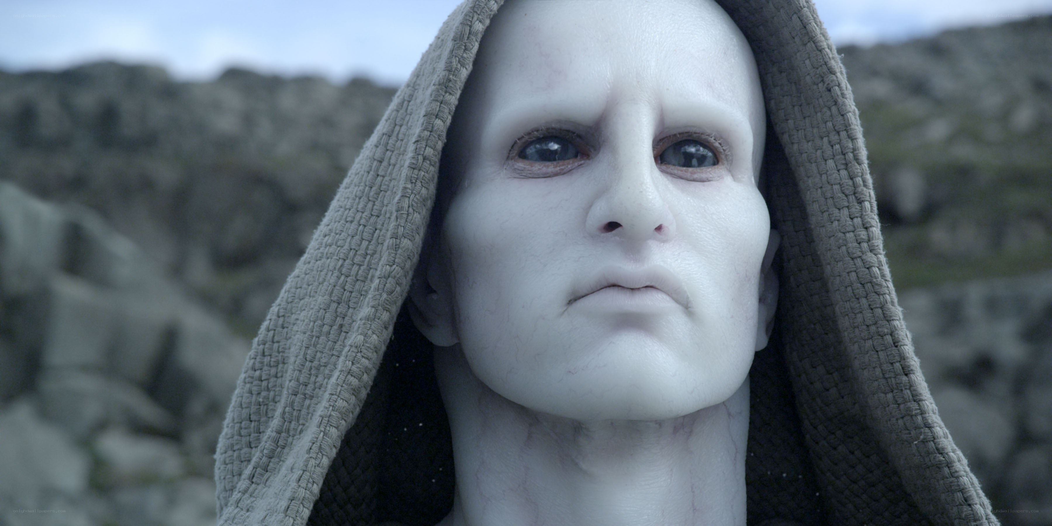 white-skinned figure in hood