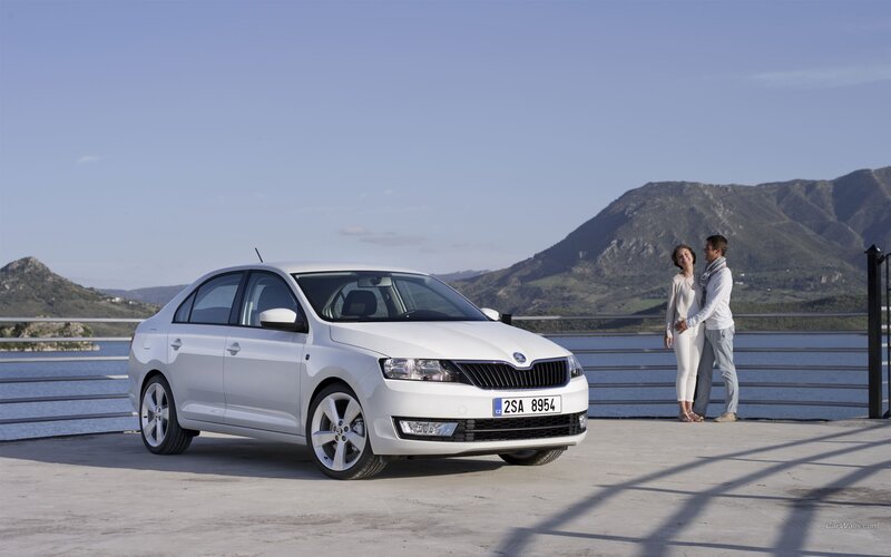 White Skoda sedan by the water