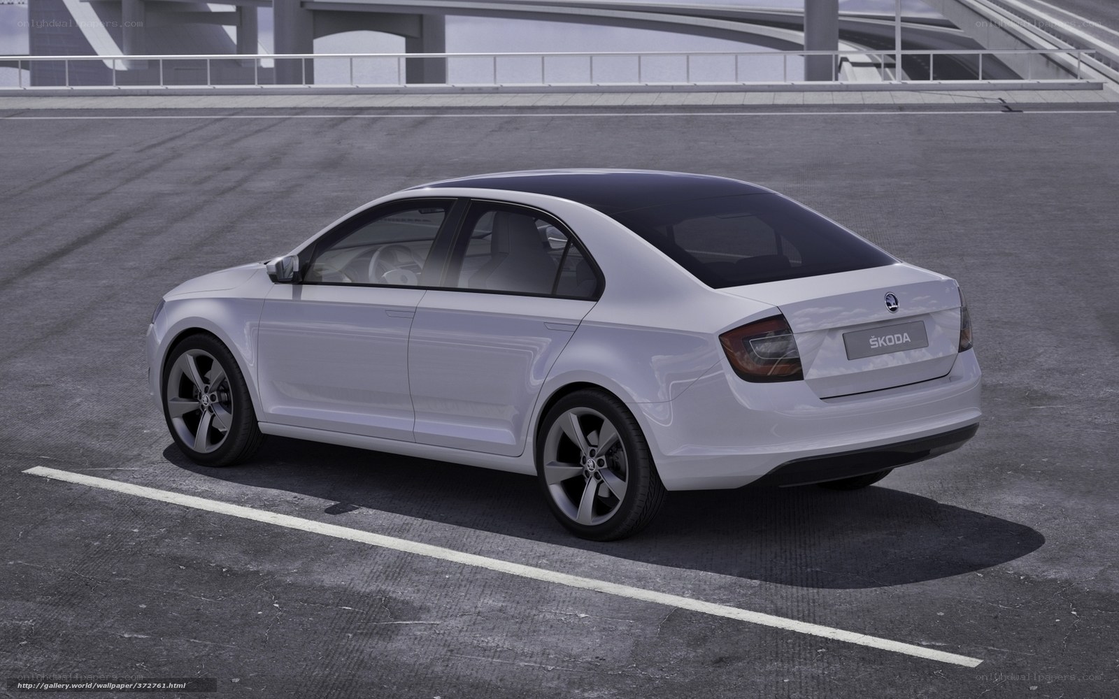 White Skoda sedan on asphalt