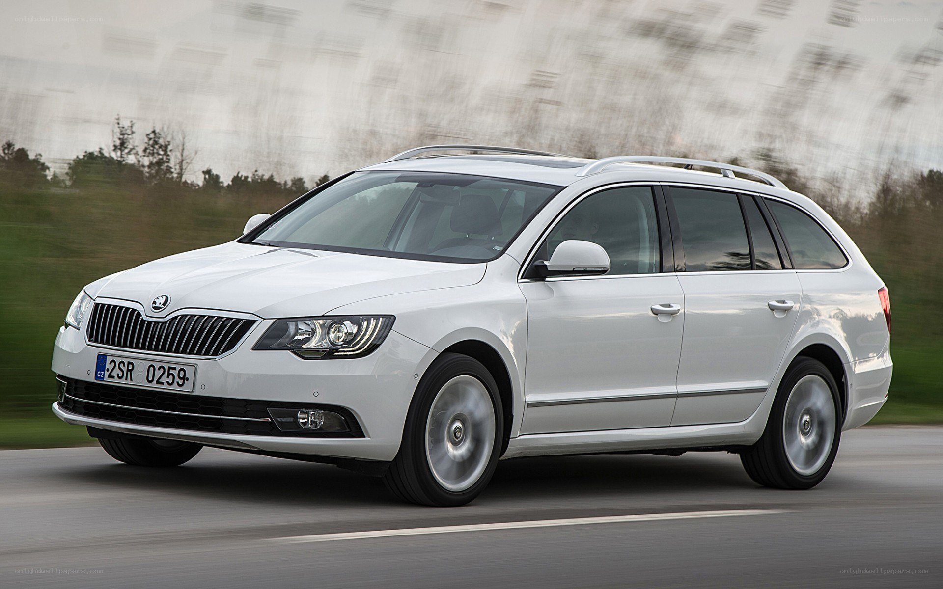 white skoda station wagon in motion