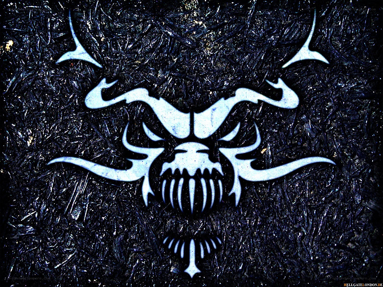 white skull logo on dark background