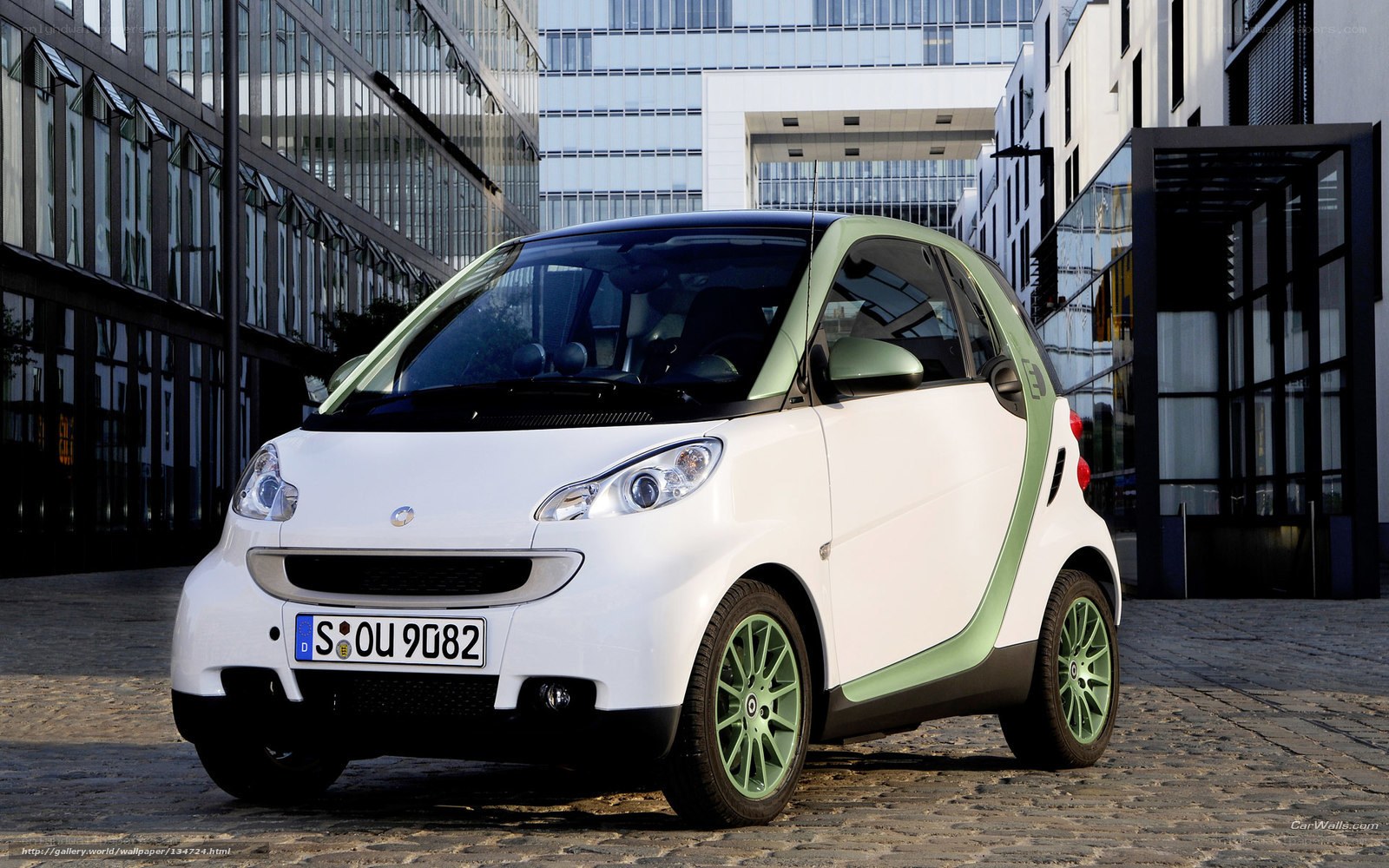 white smart car on cobblestones