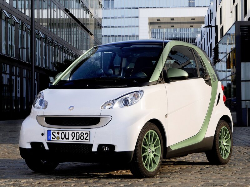 white smart car with green accents