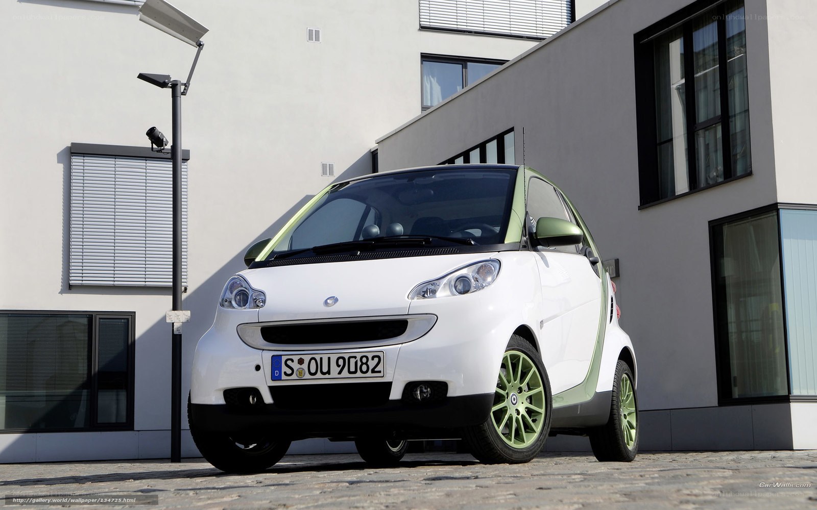 white smart car with green accents