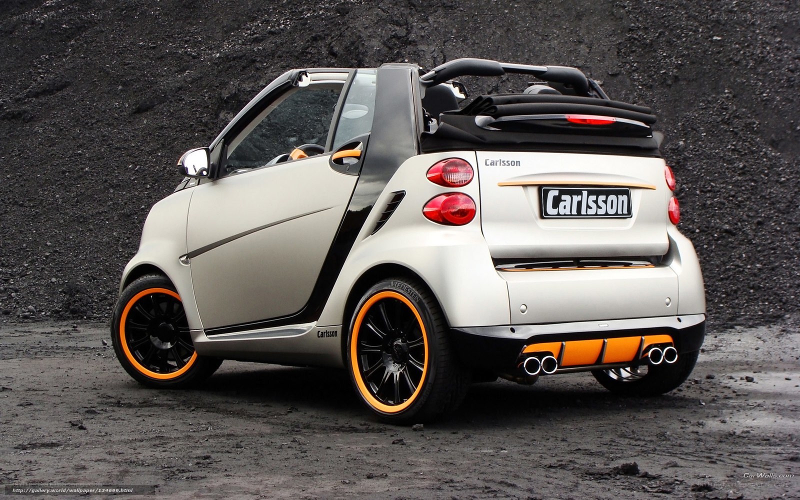 white smart car with orange accents