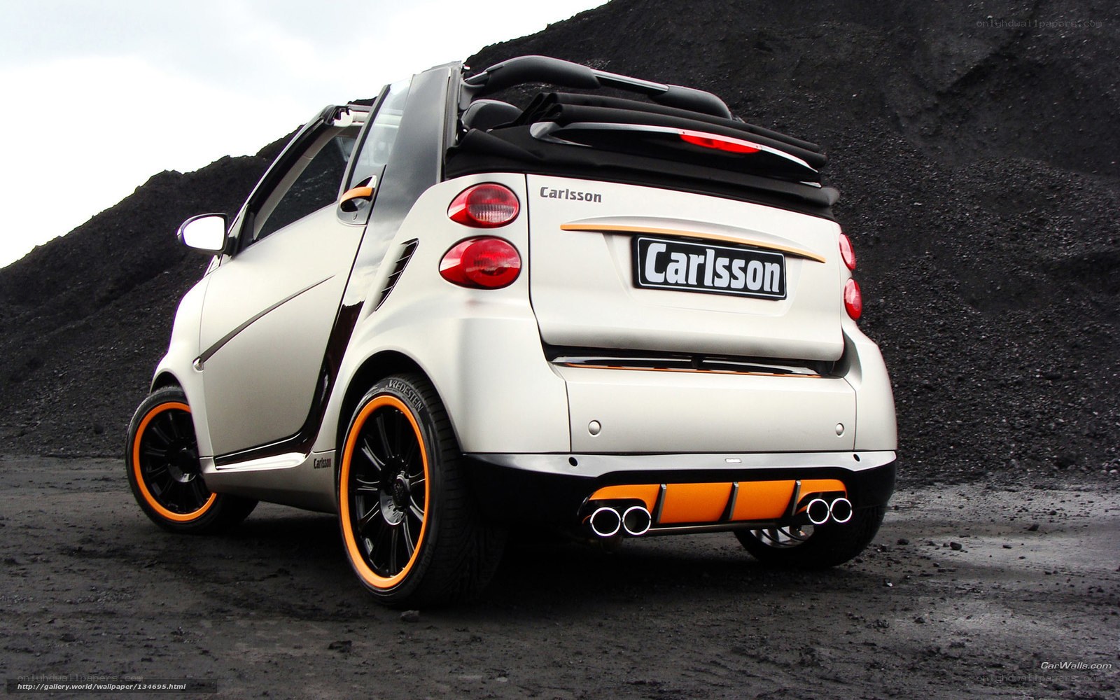 white smart car with orange accents