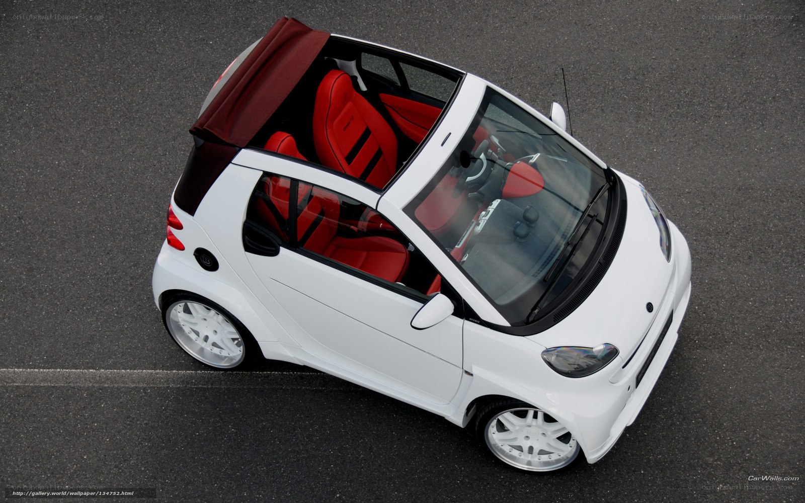 white smart car with red interior