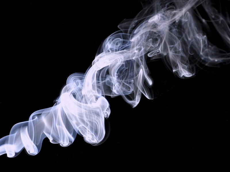 White smoke swirls on black