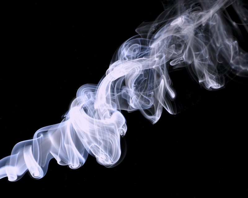 white smoke swirls on black