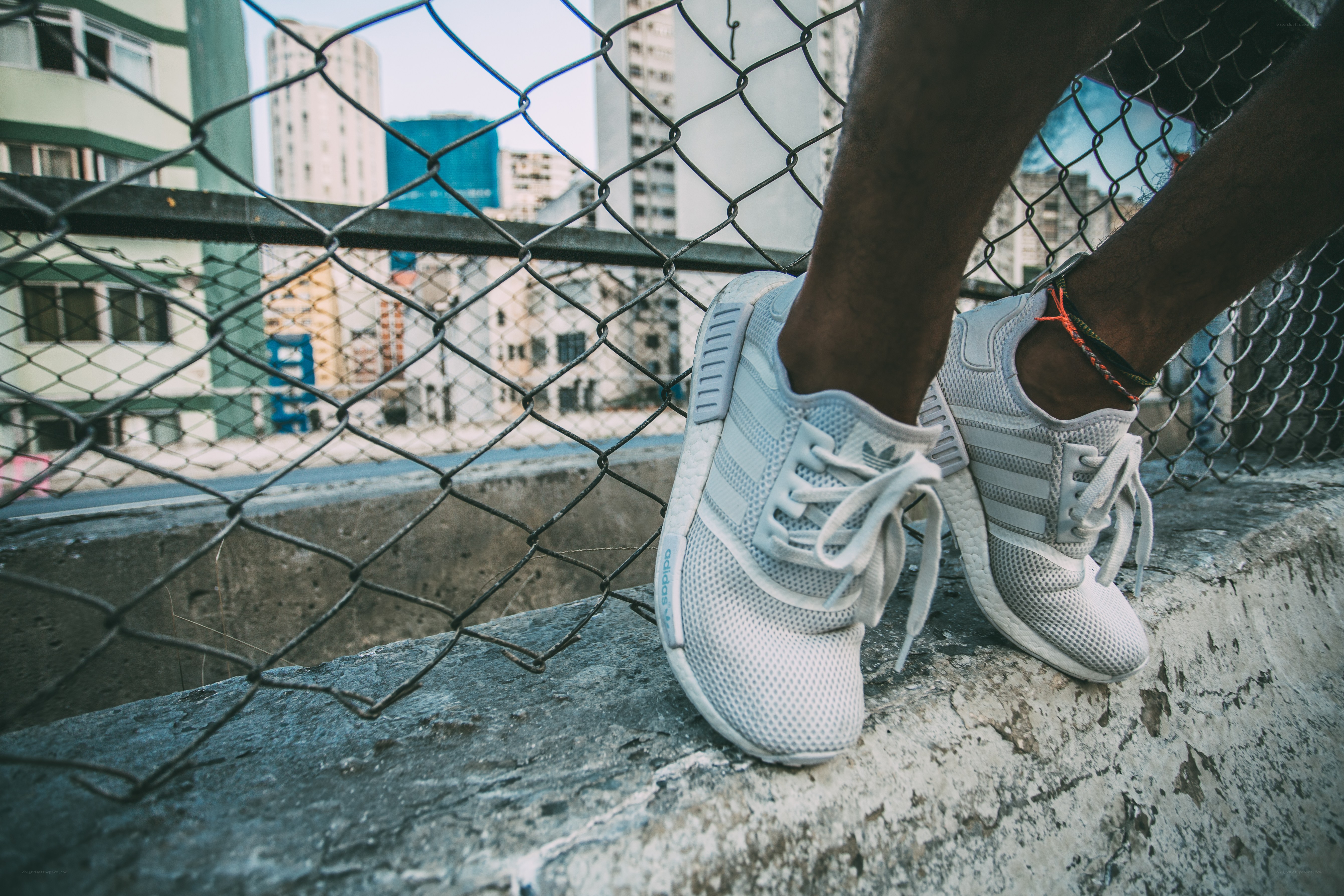 white sneakers on concrete ledge