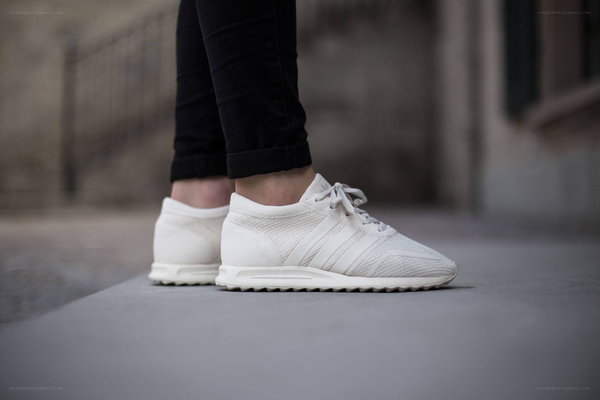 white sneakers on concrete