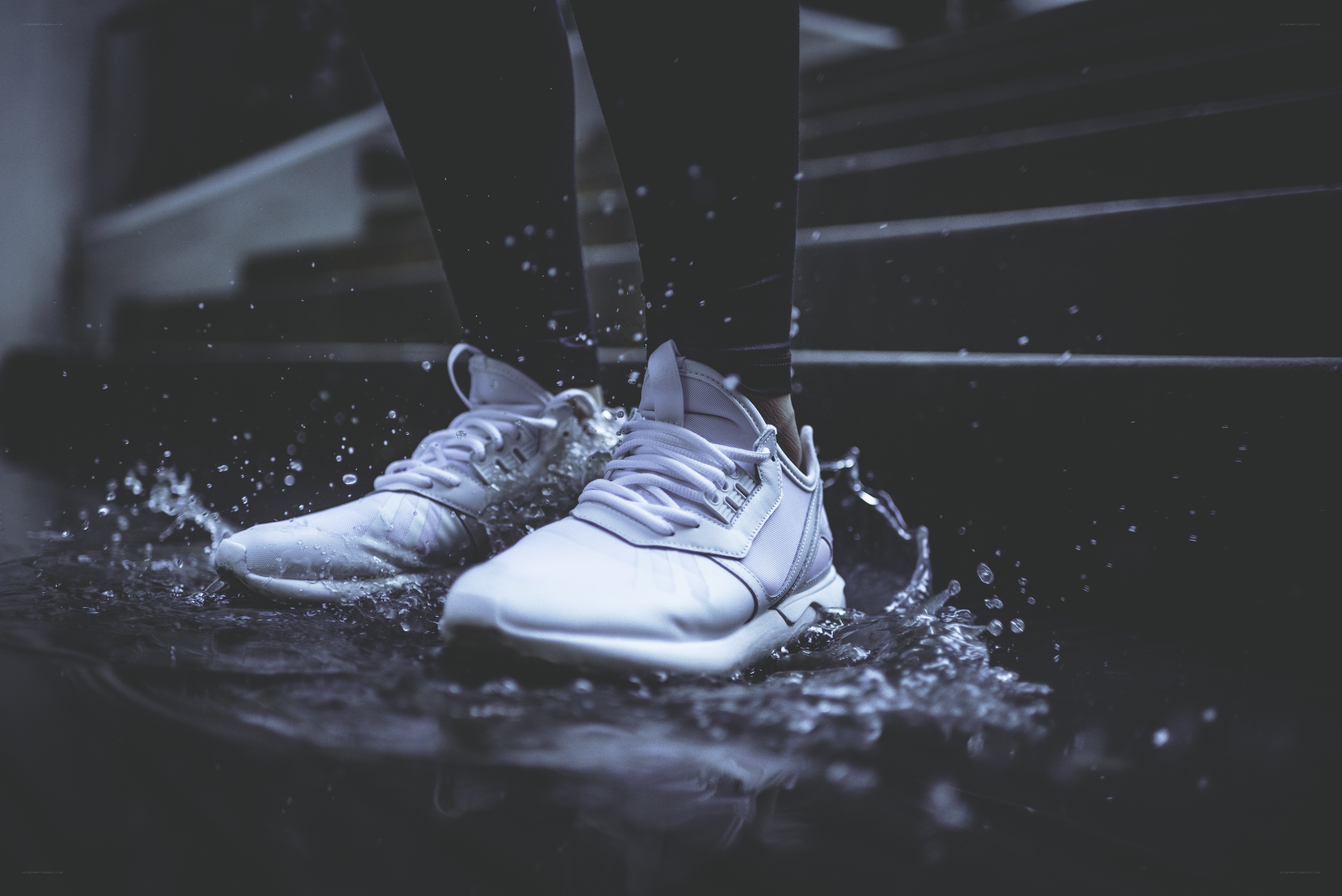 white sneakers splashing water