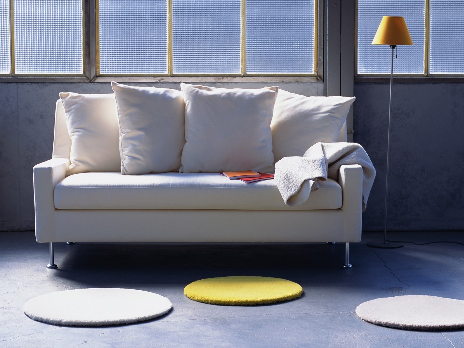 White sofa with circular rugs